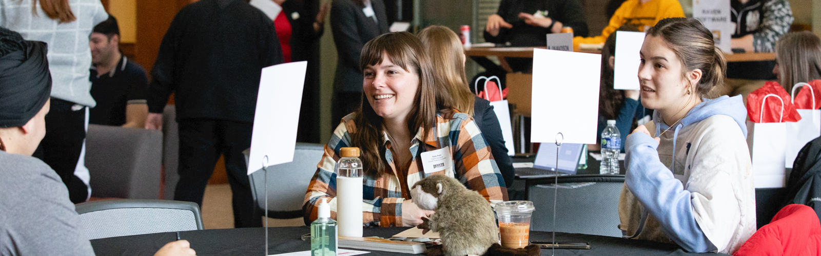 Students speaking with advisor at a career connector